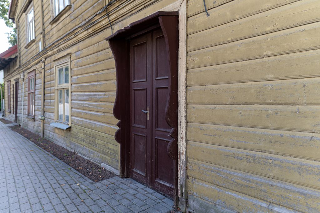 Exterior Painting: A wooden house showcasing a worn facade
