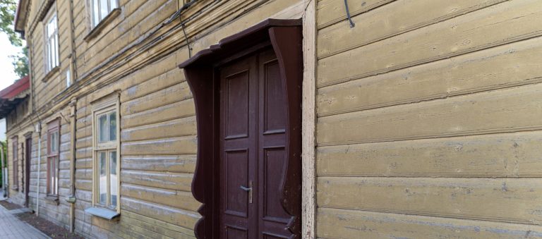 Exterior Painting: A wooden house showcasing a worn facade